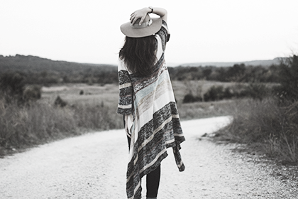 Nice looking woman standing next to the lake