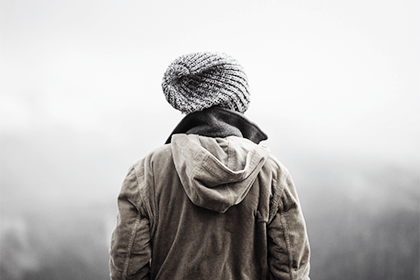 Boy standing in the cold forest in clothes