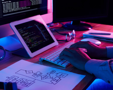 Person coding in the really nice room with purple background